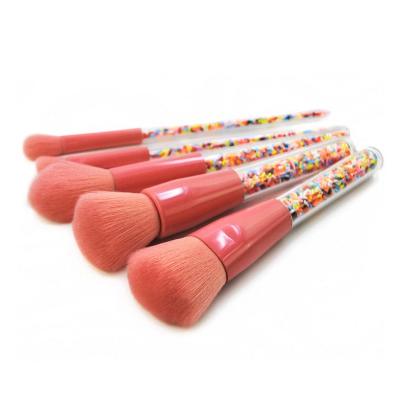 Digitaldistribution375 makeup brushes with coral-pink bristles, matching ferrules, and clear sprinkle-filled handles.