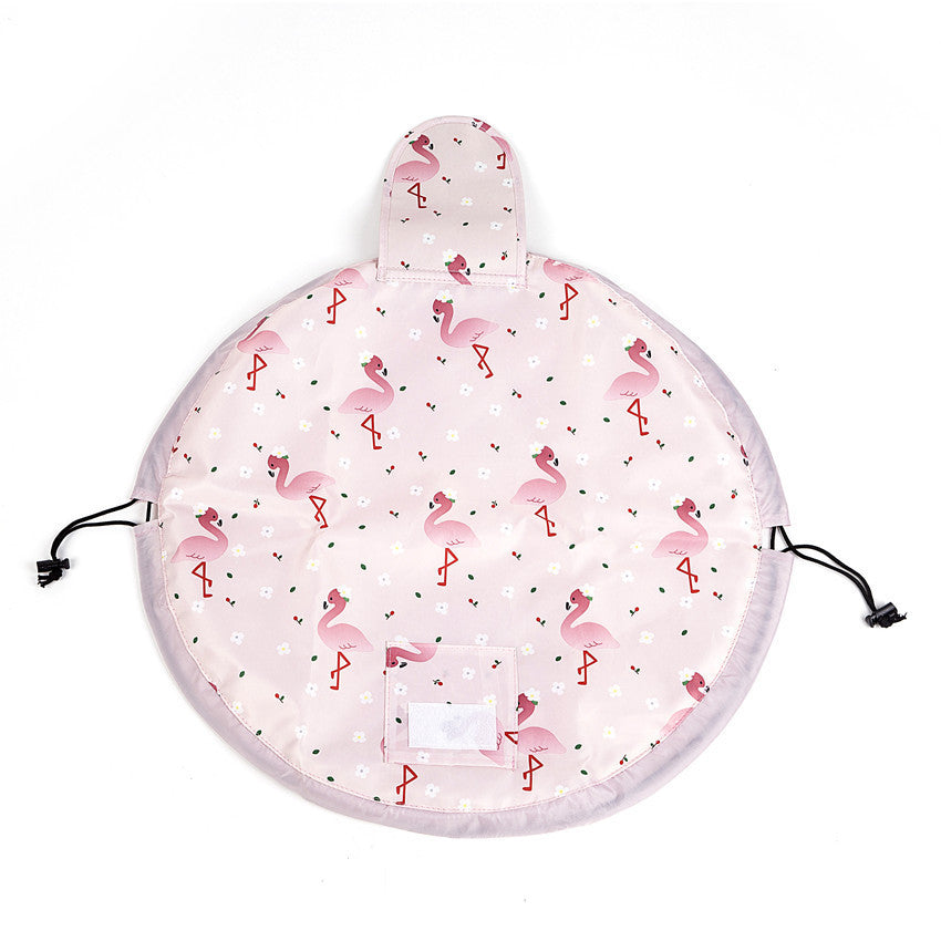 Pink fabric drawstring cosmetic bag with flamingo and flower print, featuring a velcro pocket and black cord closure.
