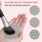 A hand cleaning a makeup brush on a grey silicone mat with varied textures for deep cleaning.