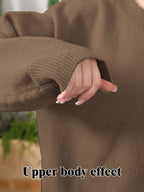 Close-up of a person wearing a soft, brown knit sweater with ribbed cuffs. Text overlay reads "Upper body effect."