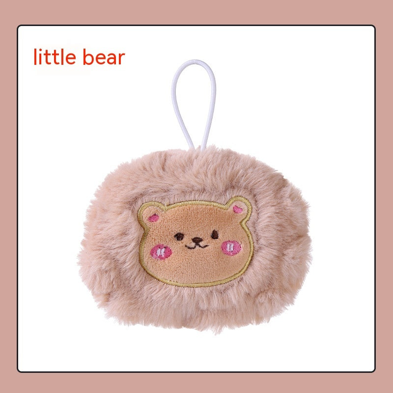 Fluffy beige plush hand warmer with a cute embroidered bear face and a white hanging loop.