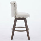 Beige tufted velvet swivel bar stool with nailhead trim and brown wooden legs on a white background.
