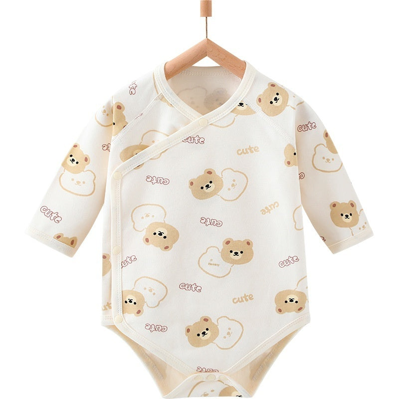 Cream-colored cotton baby romper with a cute bear and "cute" text pattern, featuring a side-snap closure.