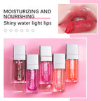 Five rectangular tubes of tinted lip glow oil with silver caps, showing high-shine, glossy, pink-toned lips.