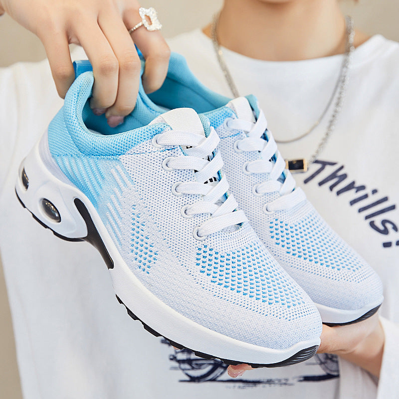 Light blue and white knit lace-up running shoes featuring a thick white cushioned sole with visible air pocket detail.
