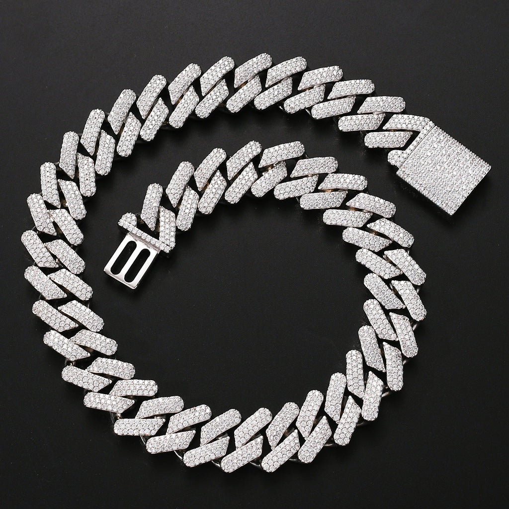 Silver-tone hip hop cuban link chain fully encrusted with shimmering white zircon crystals on a black background.