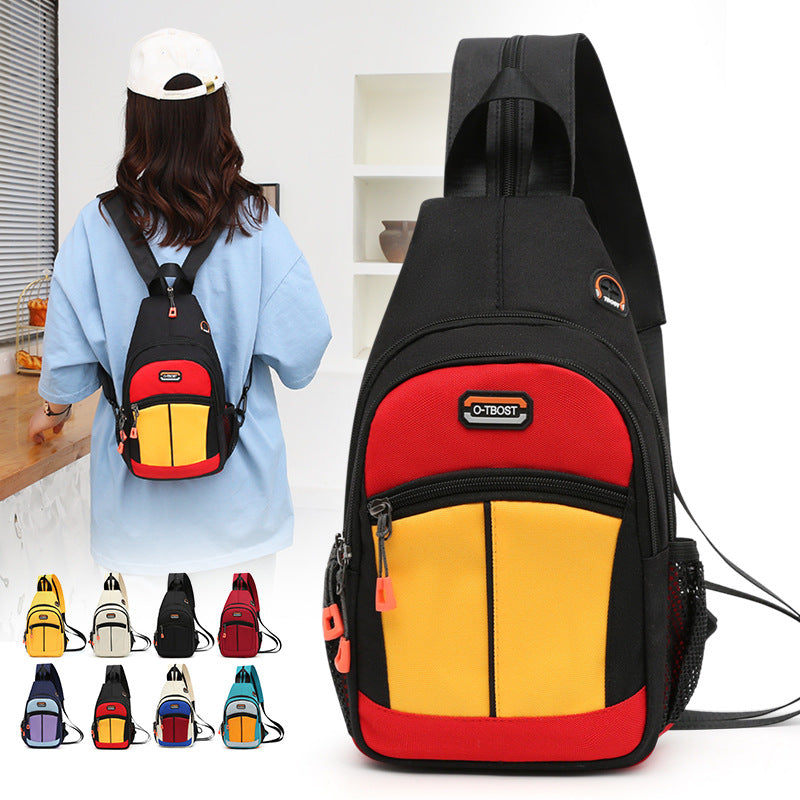 A woman wears a black, red, and yellow multifunctional sling backpack with a USB port and mesh side pocket.