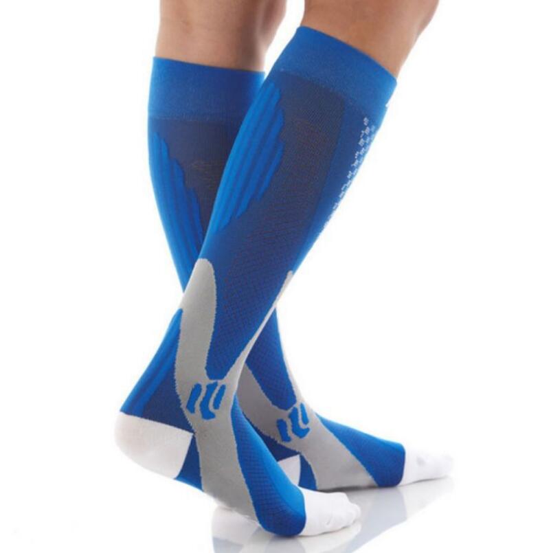 Blue and grey athletic compression socks with white toe and heel, shown on lower legs against a white background.