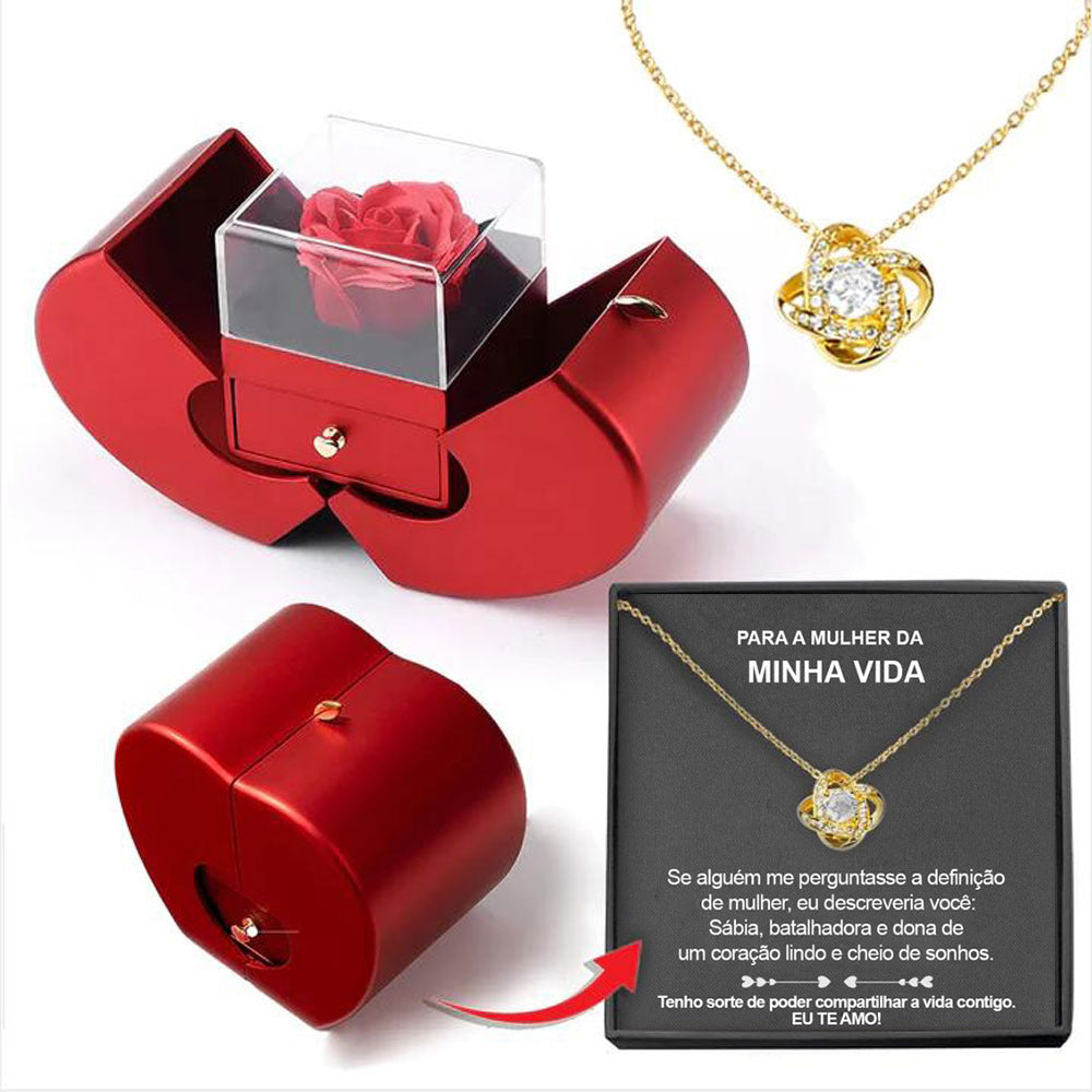 Red apple-shaped jewelry box with an eternal red rose, plus a gold necklace with a knot pendant and gift card.