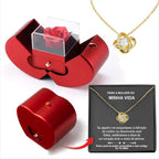 Red apple-shaped jewelry box with an eternal red rose, plus a gold necklace with a knot pendant and gift card.