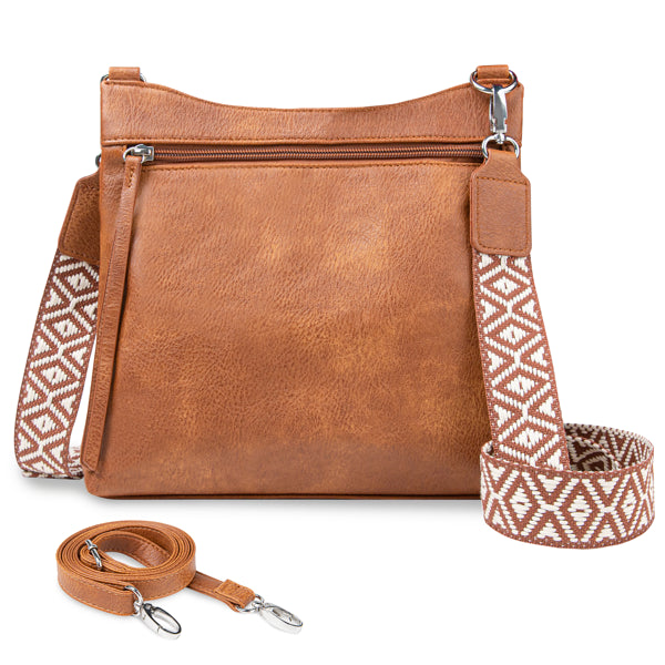Brown faux leather crossbody bag with front zipper pocket and two interchangeable patterned and solid straps.