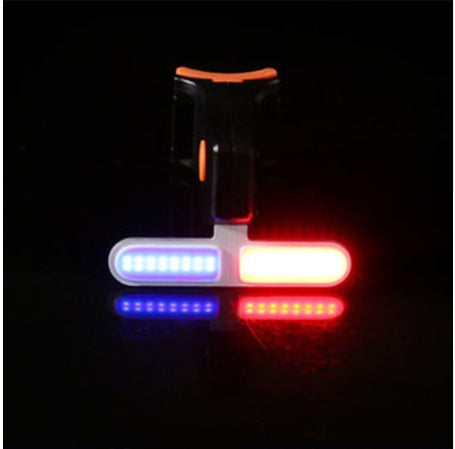 USB bicycle taillight with T-shaped mount, featuring bright blue and red LED light strips on a black base.