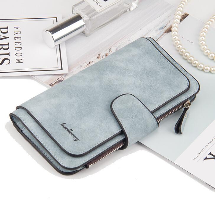 Light blue faux suede long wallet by Baellerry with a snap-button flap, side zipper, and minimalist design.