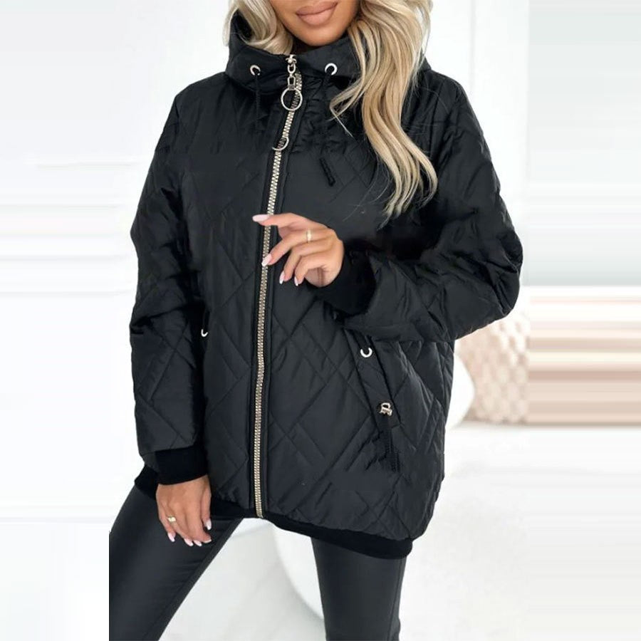 Woman wearing a black, diamond-quilted hooded coat with a full-length zipper, ribbed cuffs, and drawstring details.