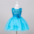 Bright blue baby sequin dress with a tulle skirt and a matching fabric flower at the waist on a mannequin.
