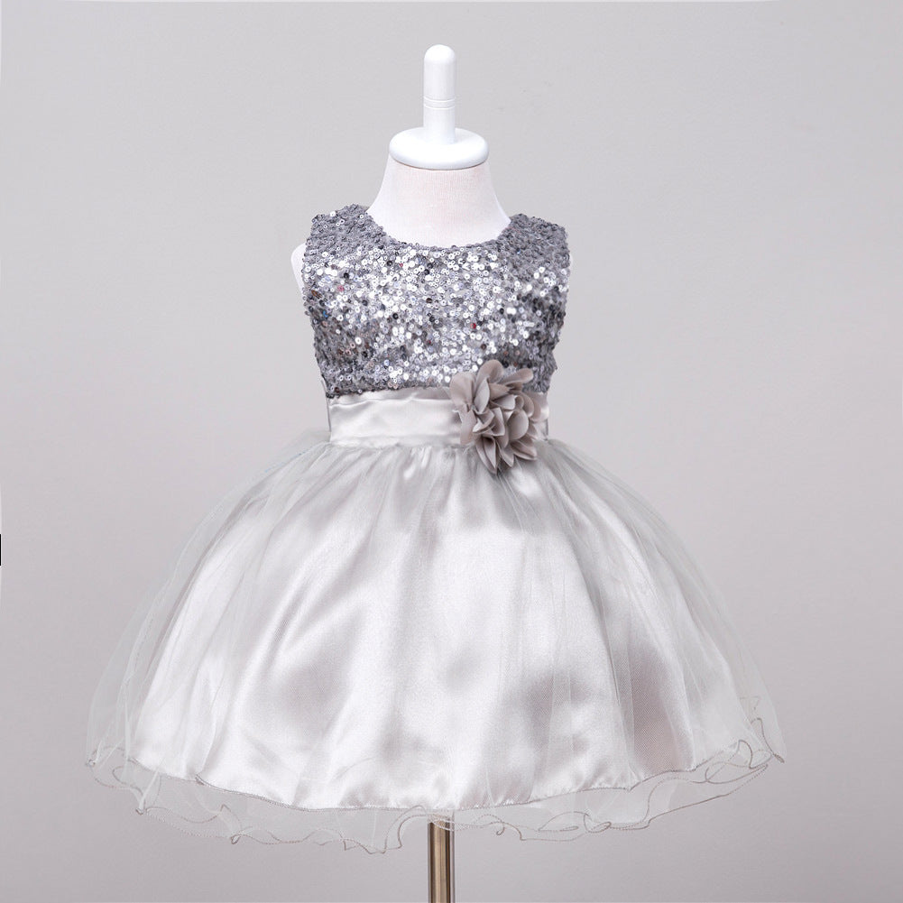 Silver baby flower girl dress with sequined bodice, satin waistband, fabric flower accent, and layered tulle skirt.