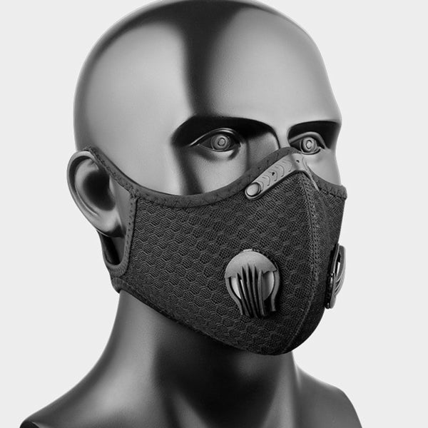 Black, reusable half-face mask with a honeycomb mesh design and dual side air valves on a mannequin head.