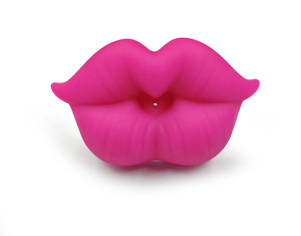 Digitaldistribution375 funny silicone baby pacifier shaped like bright pink, full, puckered lips on a white background.