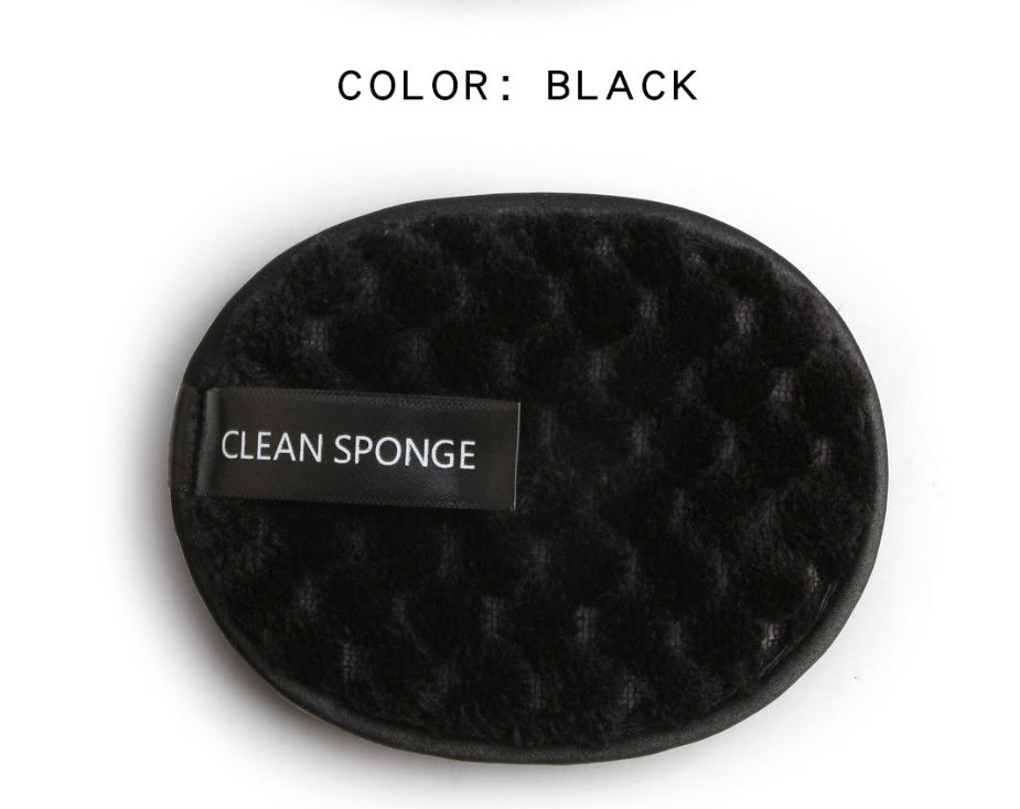 Oval, black textured cleansing sponge with a "CLEAN SPONGE" label on a white background.