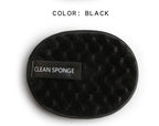 Oval, black textured cleansing sponge with a "CLEAN SPONGE" label on a white background.