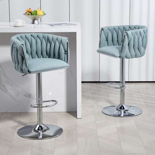 Two light blue fabric bar stools with woven backs, chrome swivel bases, and footrests by a white kitchen island.