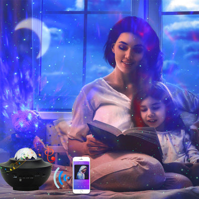 Black USB-powered LED projector light with music player features, casting a colorful moon and star night-sky effect.