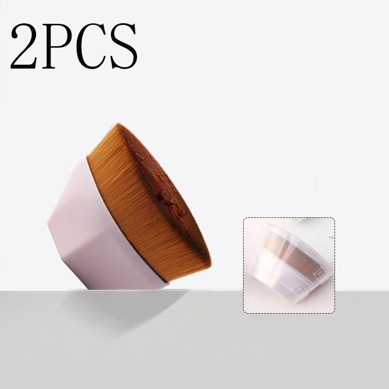 Two flat, round makeup brushes with light pink handles and soft brown synthetic bristles, plus a protective cover.