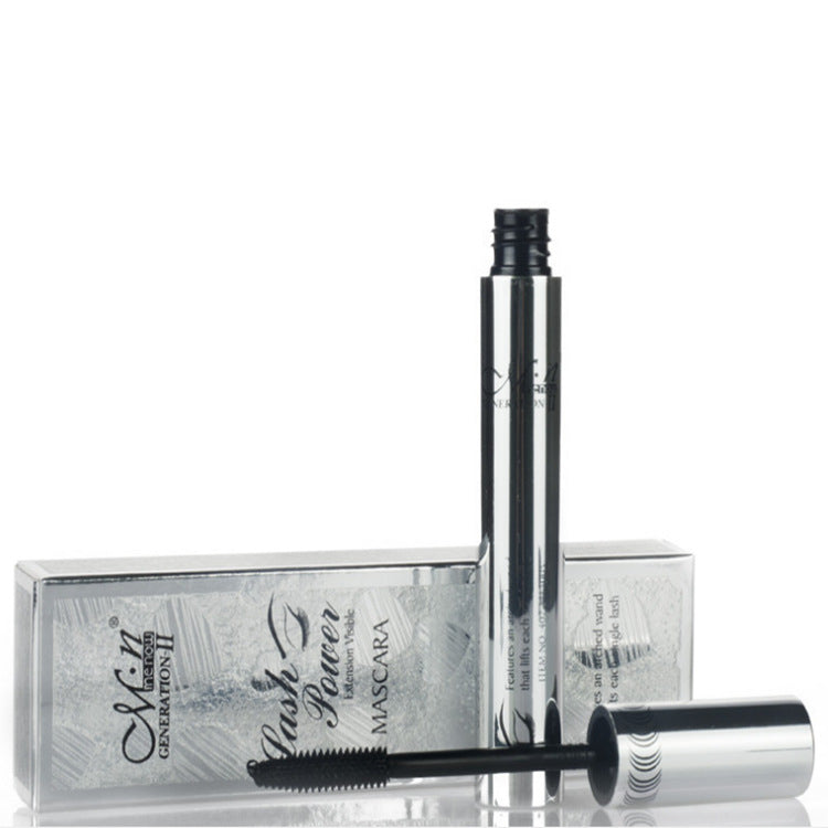M.N Generation II Lash Power mascara in silver chrome packaging with a black wand, displayed with its box on white.
