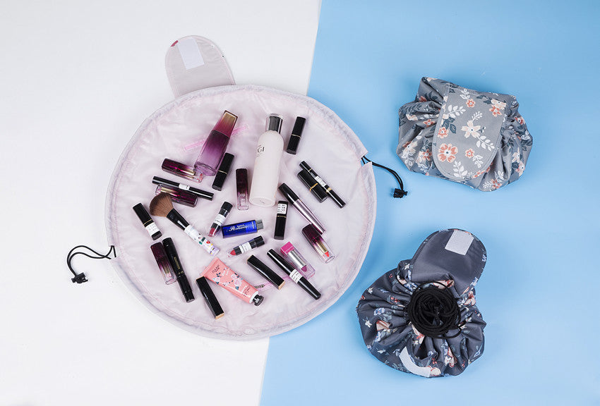 Floral-patterned, drawstring cosmetic bags in open and closed states, filled with assorted makeup items.