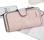 Dusty pink faux leather wallet with a snap-button flap closure and the "baellerry" brand name embossed on the front.