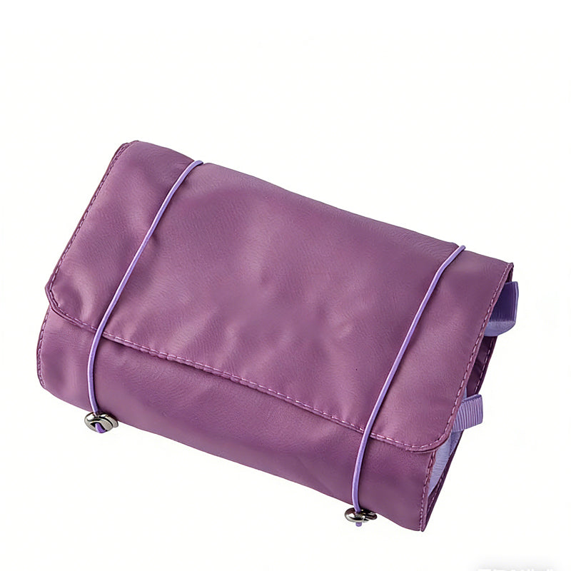 A purple, rectangular 4-in-1 travel storage bag made of smooth material, secured with light purple elastic cords.