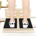 Wooden slant board for home fitness with two black non-slip grip pads for standing exercises.