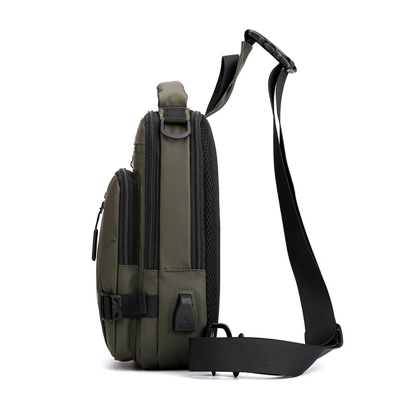 Olive green, water-resistant tactical crossbody bag with black zippers, USB port, and padded mesh back panel.