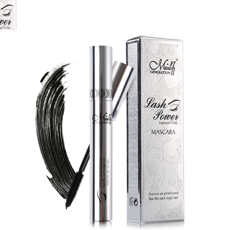 M.N Lash Power mascara tube and silver box next to a black mascara wand swipe on a white background.