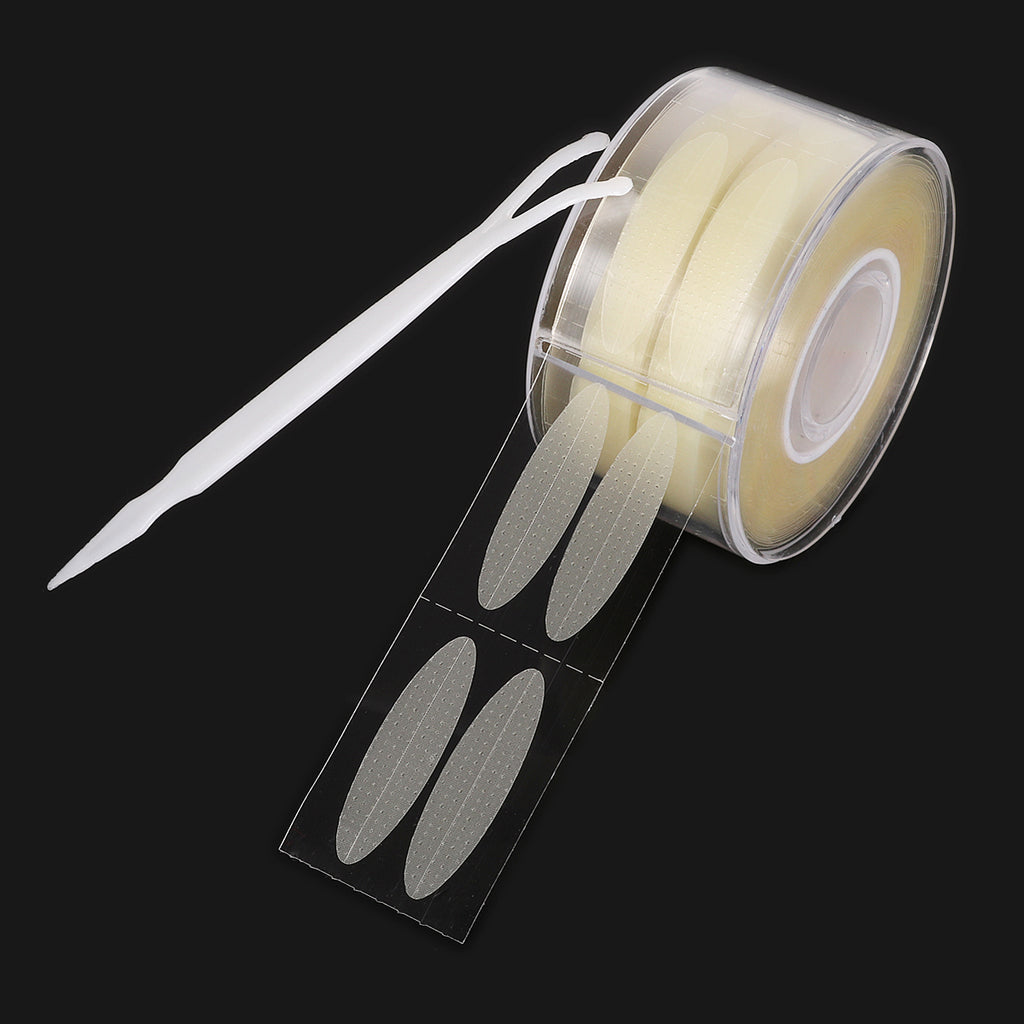 Clear beige adhesive double eyelid tape strips on a roll with a white plastic application fork.