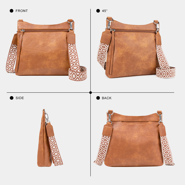 Brown faux leather crossbody bag with multiple zippered pockets and a patterned, adjustable wide guitar-style strap.