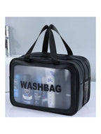 Black travel wash bag with clear window, dual zip compartments, and handles. Contains toiletry bottles inside.