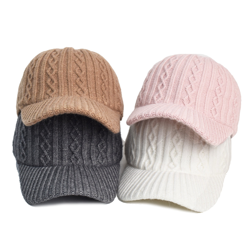 Four cable-knit baseball caps in beige, dark gray, pink, and white stacked against a plain white background.