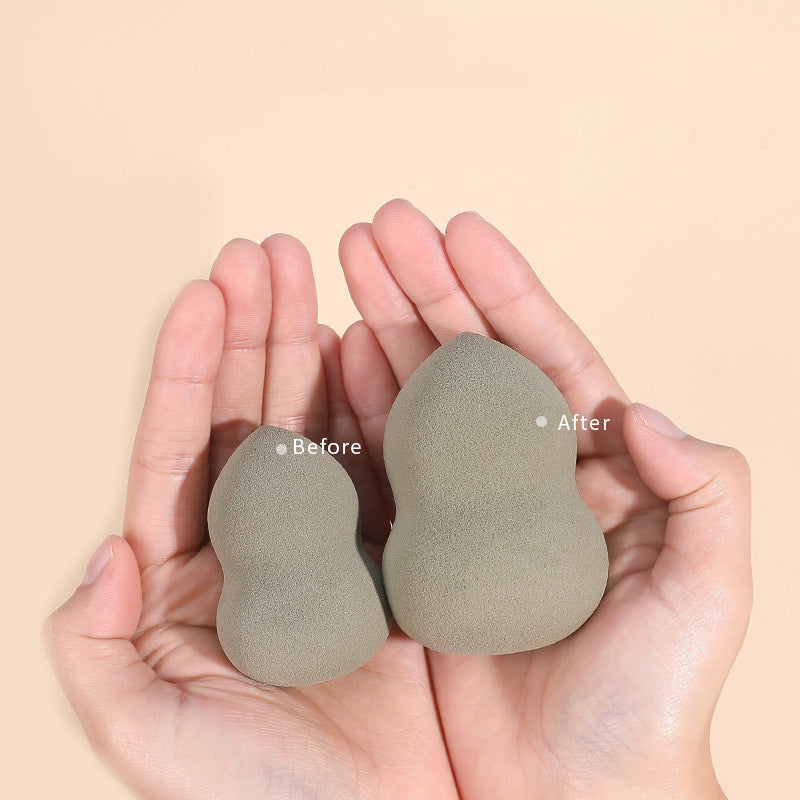 Hands holding two grey makeup sponges showing size difference between dry (Before) and wet (After) states.