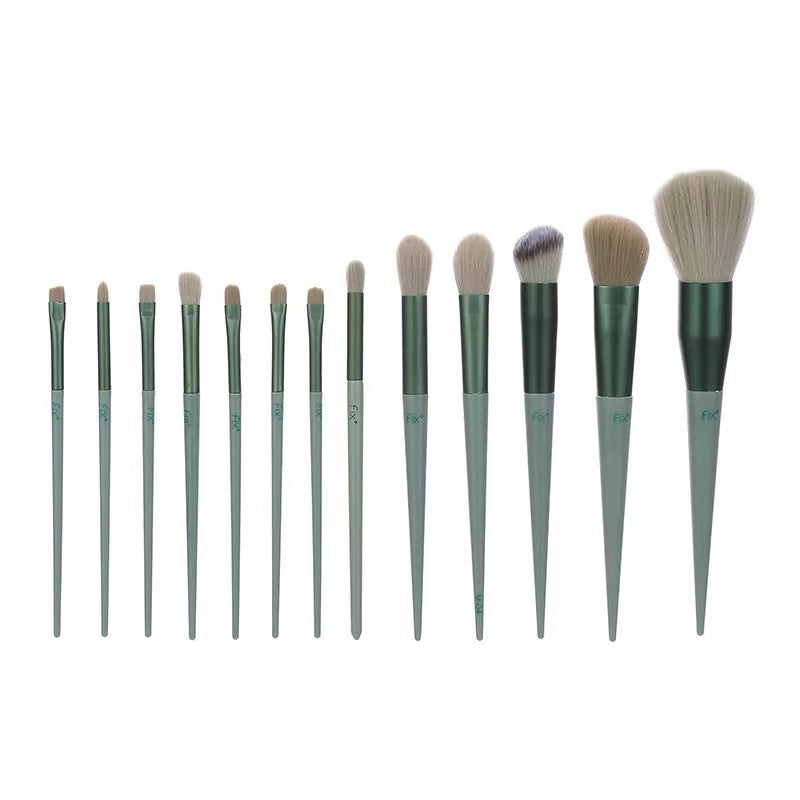 13-piece makeup brush set with sage green handles, dark ferrules, and soft synthetic bristles of varying sizes.
