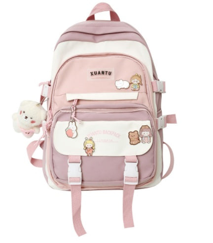 Pink and white Korean-style nylon backpack with buckle straps, character pins, and a plush bear charm.