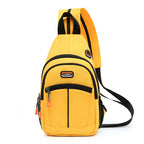 Bright yellow canvas crossbody backpack with black trim, zippers, side mesh pocket, and built-in USB port.