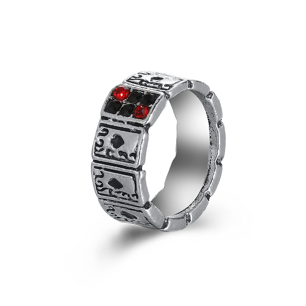 Silver-tone metal hip hop ring featuring etched playing card suits with inlaid black and red crystals.