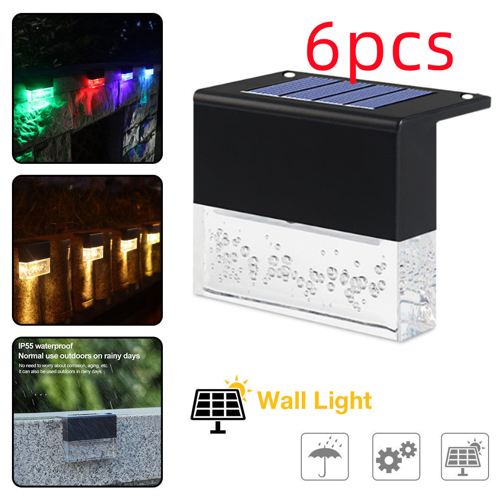 6-pack waterproof solar LED fence lights with black housing and clear, bubble-textured glass, displaying RGB colors.