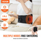 Black VEVOR red light therapy belt worn around waist with 660/850nm LED lights and handheld digital controller.