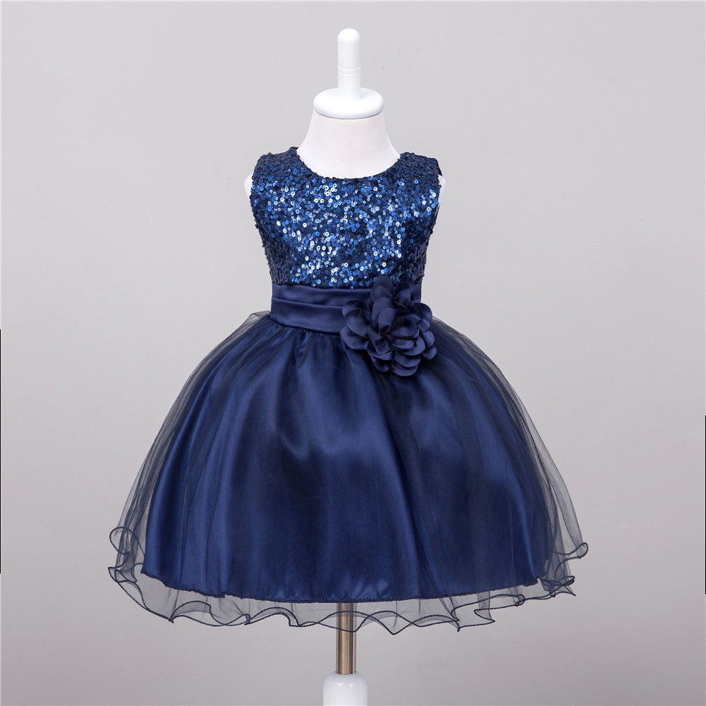 Navy blue baby princess dress with sequined bodice, satin waist, flower detail, and a full tulle skirt on a mannequin.