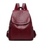 Elegant, maroon faux-leather backpack with a front flap, top handle, adjustable straps, and a kangaroo brand logo.