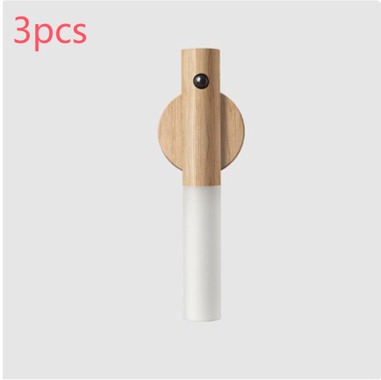 A vertical wood and white plastic motion sensor LED night light with a circular magnetic mounting base. Set of 3.