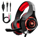 Black and red gaming headphones with LED-lit earcups, cushioned headband, boom mic, and included audio cables.