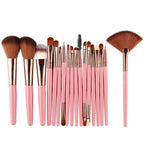 A 20-piece makeup brush set with soft brown bristles, rose gold ferrules, and pastel pink handles on a white background.